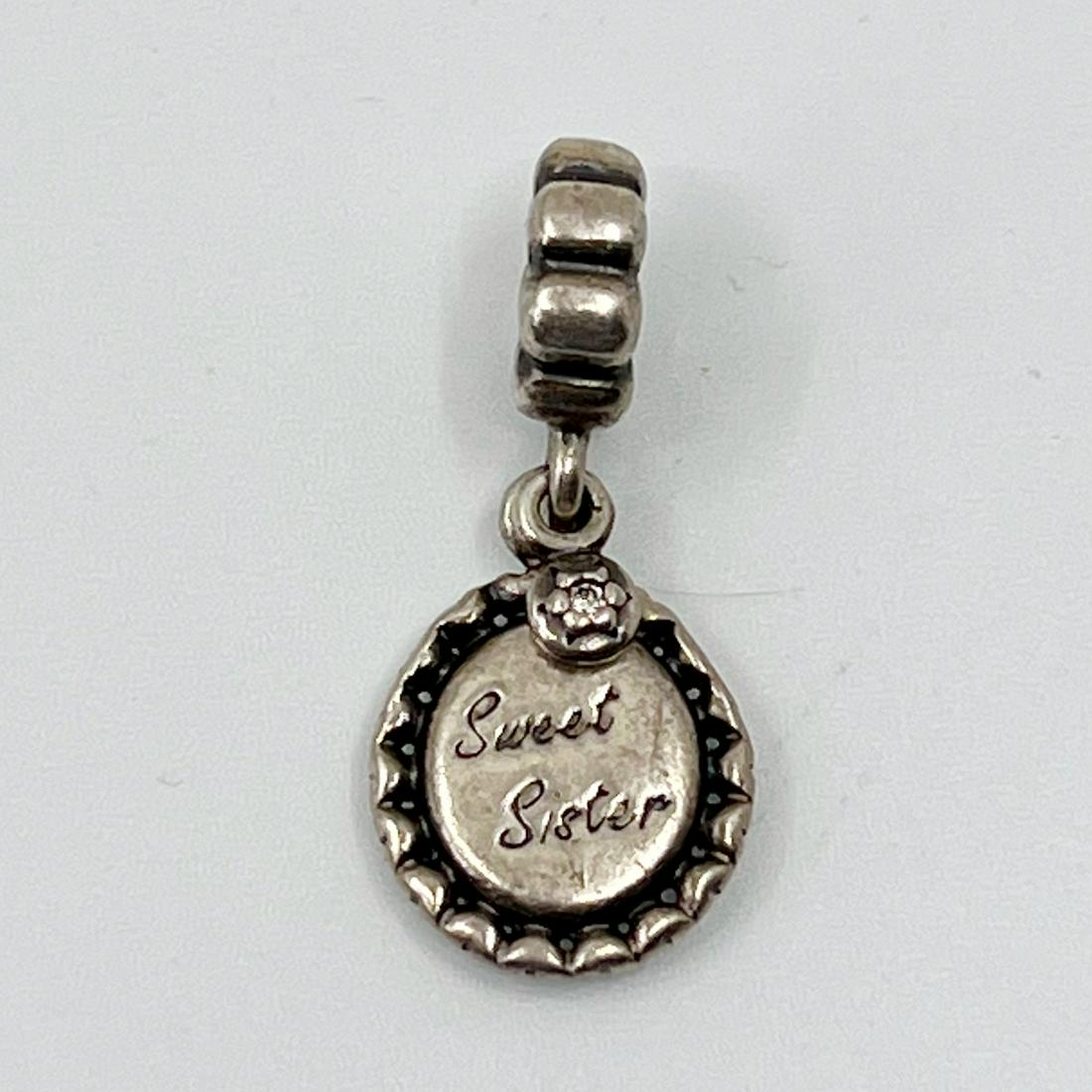 PANDORA sterling silver Sweet sister cubic zirconia charm: Measures: 1 1/8" long by 1/2" wide hallmark: 925 ale Condition: like new SKU-530