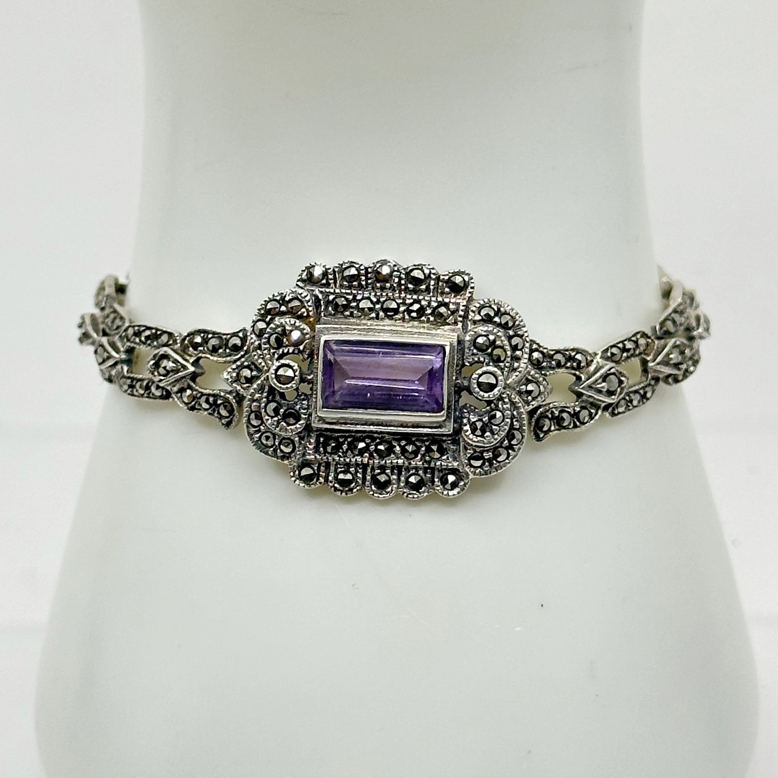 Sterling silver amethyst & marcasite bracelet: Measures 6 3/4" long by 7/8" wide Crafted with 10x6mm amethyst & marcasites Hallmark: 925 In very good condition SKU-756