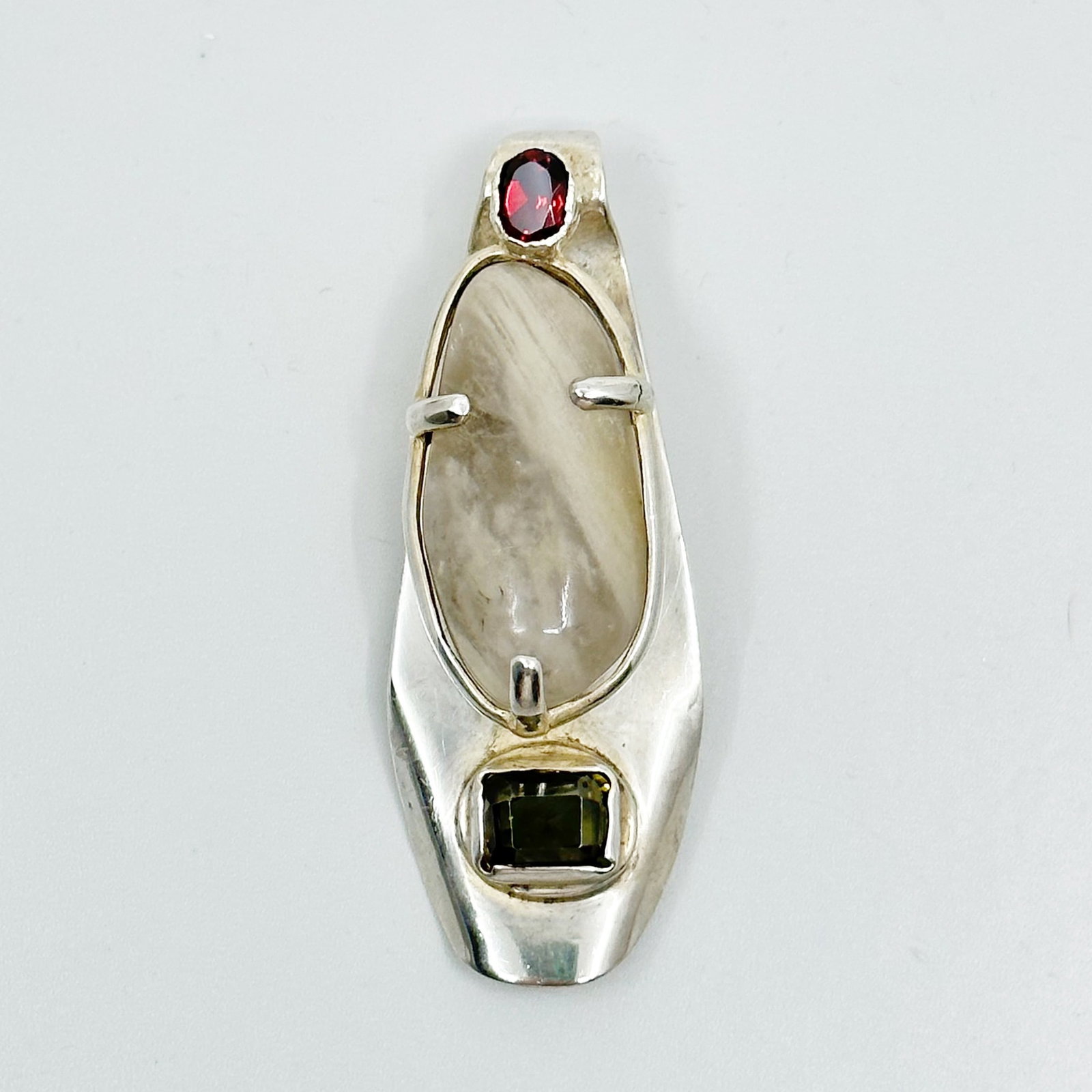 Mid Century Sterling silver garnet & quartz brooch: Measurements: 2 3/8" Long by 7/8" Wide Material: sterling silver Gemstone: garnet, rutilated quartz & smoky quartz Condition: Like new SKU-968