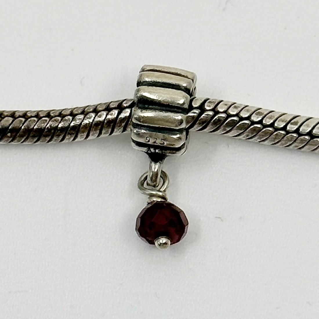 PANDORA sterling silver garnet bead January bead Charm: Measures: 5/8" long by 5mm wide Crafted with 4mm garnet bead hallmark: 925 ale In very good condition SKU-1148
