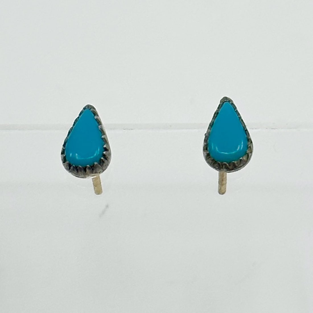 Zuni sterling silver turquoise stud earrings: Measures: 7mm long by 5mm wide Gemstone: turquoise Hallmark: N/A but tested as sterling silver In very good condition Note: the post backs are gold filled SKU-1541