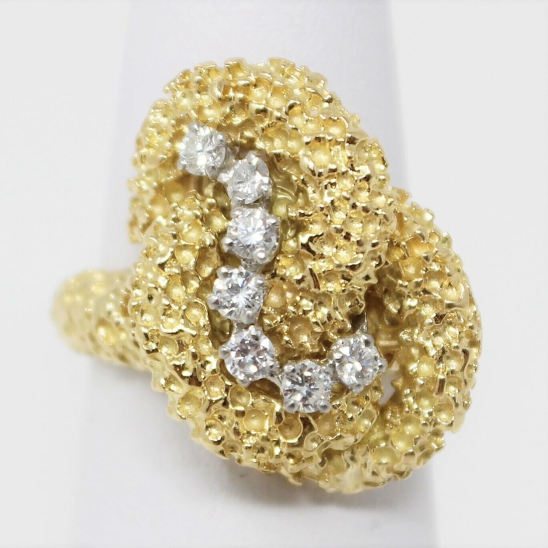 McTeigue 18k yellow gold diamond ring: Measurements: 5/8" wide Gemstone: .35 carat VS2 diamond Size: 6 1/4 Signed: IRID PLAT / 18K / McT weights: 10.9 grams in very good condition