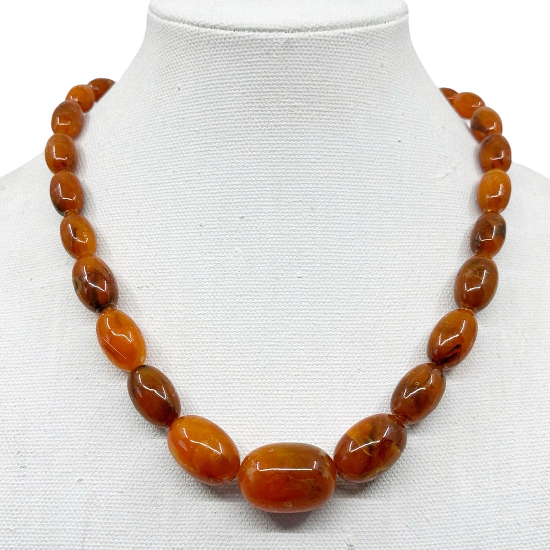 Vintage graduated amber lucite bead necklace SKU-2051: Measures: 30" long Crafted with 16x10mm to 30x21mm amber tone lucite beads Hallmark: N/A In good condition SKU-2051