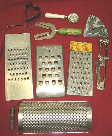 Great Lot of Old Kitchen Utensils w Advertising: 4 different graters including one with the original "Fels-Naptha Soap Chips" paper label, old deer & heart cookie cutters, a "Grip-All" cap opener with Billings Montana advertising (very worn), a swee