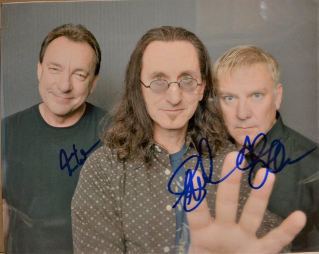 Rush Autograph Photo , Rusg Sign Photo , Rock and Roll: Awesome very tough Rush Autographs , Autograph By Geddy Lee , Neal Pert , and Alixe Lifeson . this is a very nice hard to find autograph by this famous band.. this is an absolute beautiful signed phot