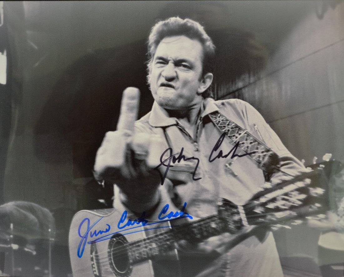 Johnny Cash Autograph Middle Finger, June Carter Cash: Very Rare Autograph Photo of the man in Black Johnny Cash and June Carter Cash , this rare photo is sign by both , June Didn't like this photo and laugh about it.. its a beautiful piece. Absolute beau