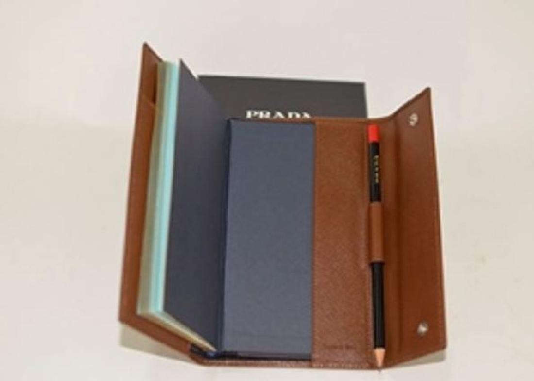 NEW Prada Tobacco Calfskin Agenda A44+A8: Brand: Prada NEW Color: Tobacco Style: Agenda A44+A8 SAFFIANO BASIC Materials: 100% calfskin Made in Italy Note: Does not include current calendar