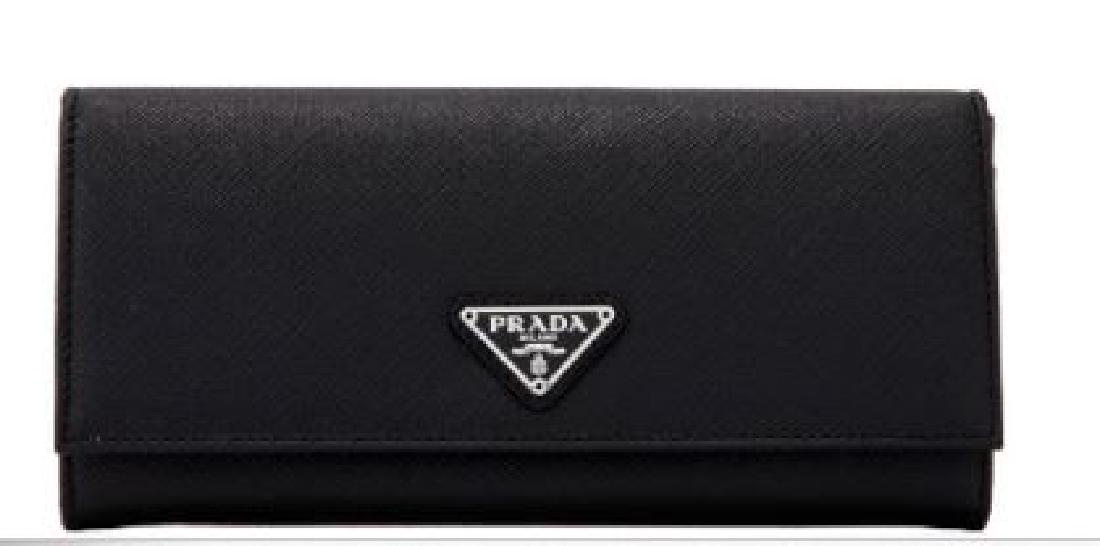 Prada Saffiano Triangle Flap Wallet: Prada Saffiano Triangle Flap Wallet Black Saffiano LeatherExterior - Saffiano leather body - Silver tone hardware - Double snap tab closure - 1 zipper pocket - Designer plaqueInterior - Leather and fa