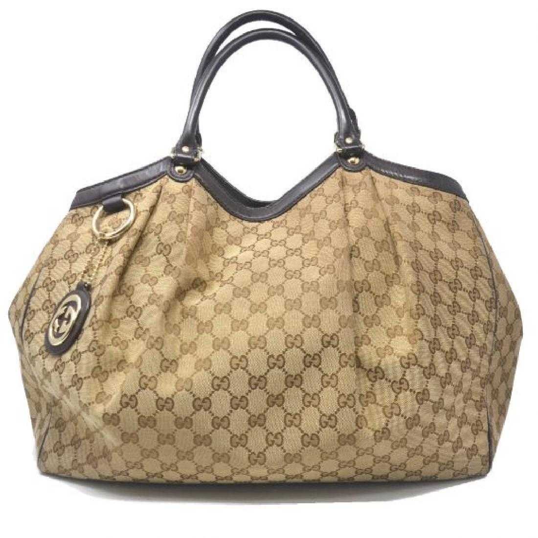 Gucci Sukey Monogram Shoulder Bag: Gucci Model Sukey Monogram Large Shoulder Bag ColorBeige/Brown Date Code211194353599 MaterialCanvas Measurements18.1â€³L x3.5â€³W x 11â€³H StrapN/A Outsidelight scuffing on the exterior of
