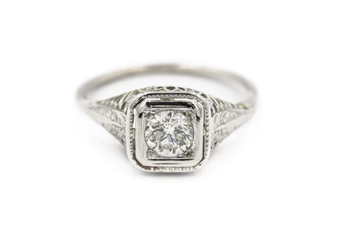 Diamond Filigree Engagement/Wedding Ring: Art Deco White Gold Diamond Filigree Engagement/Wedding Ring.Â The ring is centrally set with 1 round cut diamond weighing 0.50cts.Â It is set in a handmade open frame 18K white gold mounting th