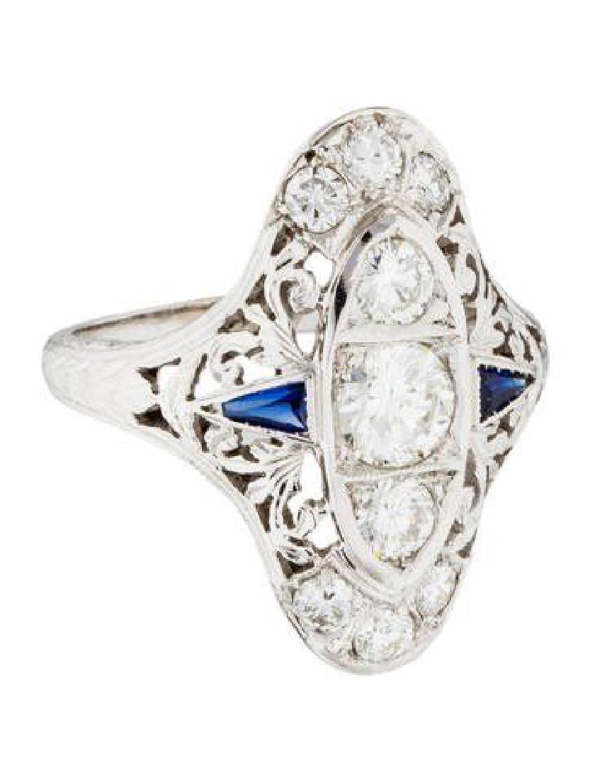 Diamond Sapphire Ring (sz4.5): Style:Art Deco Materials: Platinum Diamond and Sapphire Model: Filigree Belly Ring Metals: platinum Weight: 3.07dwt sz 4.5 Description of stones: set w/diamond weighing 0.45cts. Flanked w/ 2 round cut