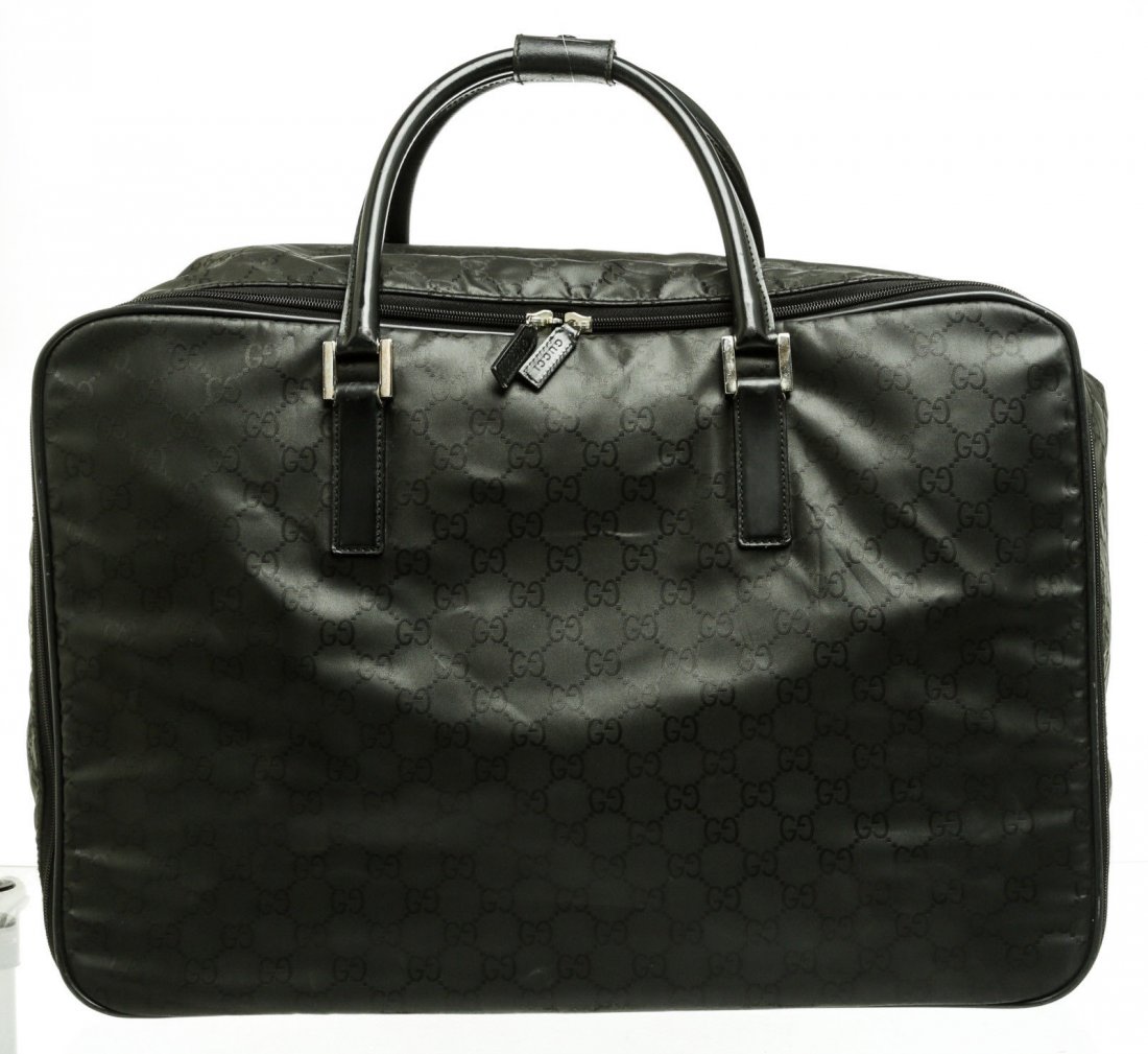 Gucci Soft Luggage: Brand: Gucci Style: Travel Bag Condition: Gently Loved/ Very Good Condition Color: Black Material: Nylon and Leather Dimensions: 24" x 16" x 8.5" handle Drop: 7" Description: Black nylon GG monogram s