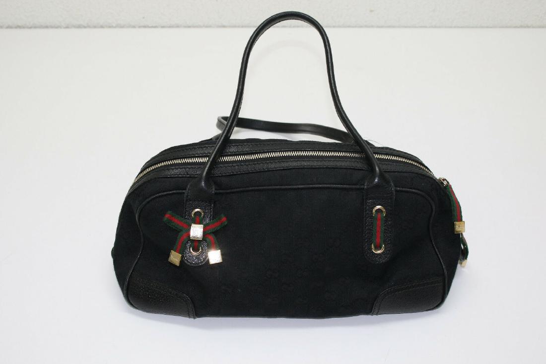GUCCI Monogram Satchel: Monogram Small Princy Satchel Black Canvas w/ Leather trim Measurements Length: 13 in Width: 5 in Height: 7 in Drop: 8 in Comes With: dust bag Fair Condition 6 out of 10 Heavy Wear and Tear Comes Wit