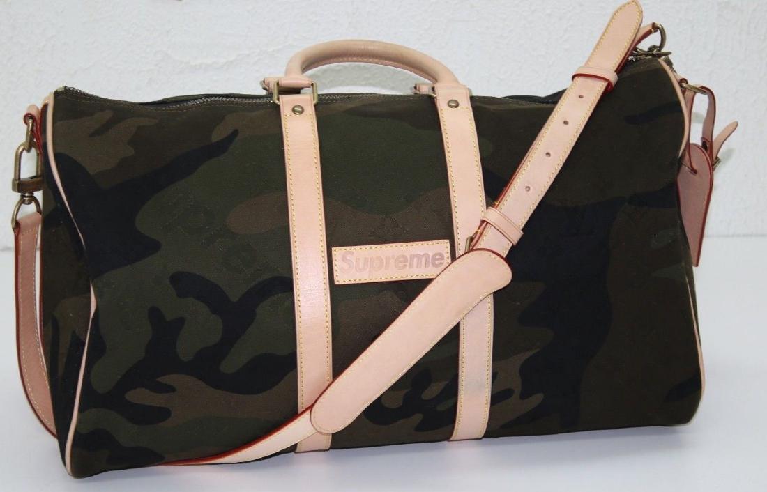 LOUIS VUITTON X Supreme Bag: LOUIS VUITTON X Supreme Monogram Camouflage Keepall 45 Bandouliere (TR2137) This stylish travel duffel is crafted of monogram and Supreme printed camouflage canvas in green. The luggage features vache