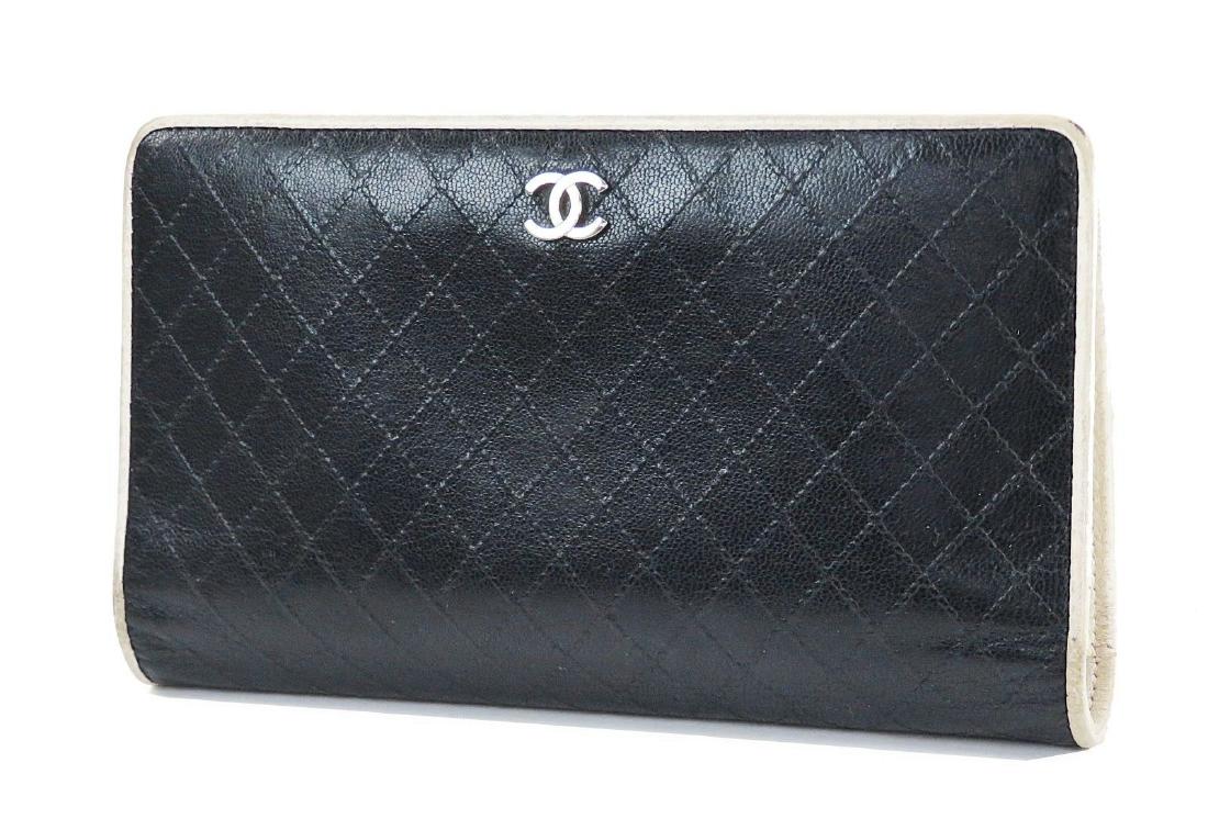 CHANEL Black Quilted Leather CC Long Wallet: Brand: Chanel Style: Black Quilted Leather CC Long Wallet Coin Purse Description: wo open pockets and bill slot with zippered coin purse between them. 8 credit card slots with 2 flat pockets behind. D
