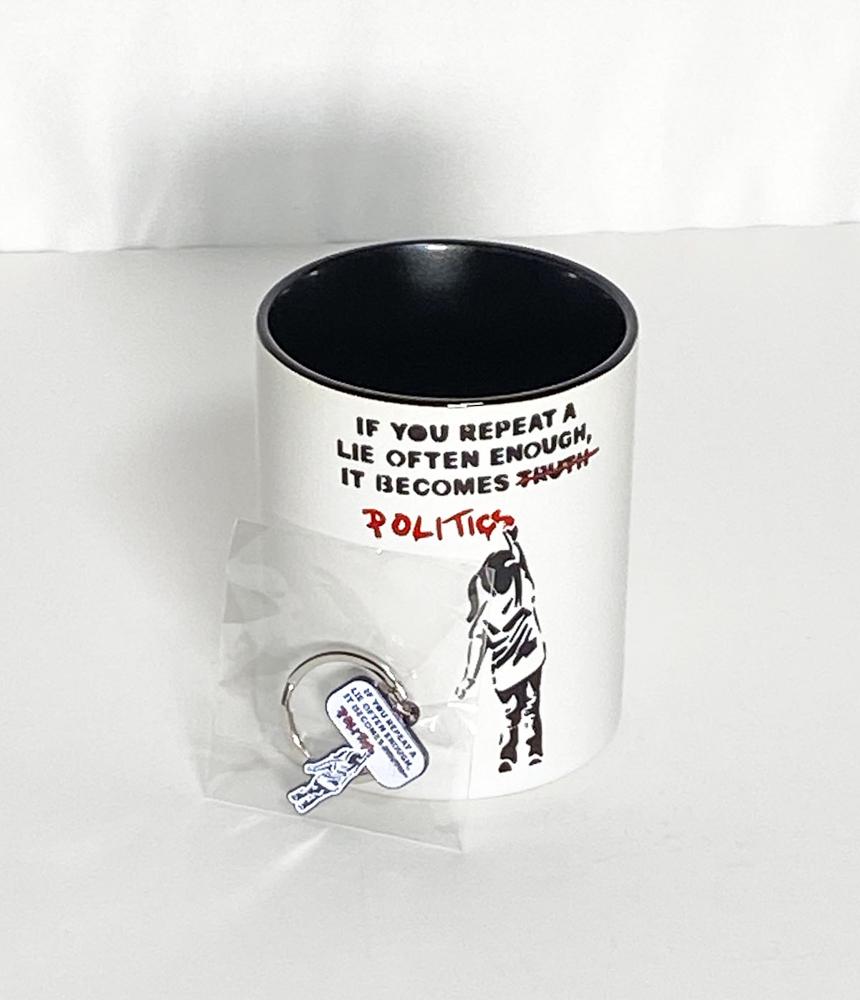BANKSY 'Politics' Mug + Keychain Set: 'Politics' by Banksy 3.75 x 3.25 Inches (mug) 1 Inch (keychain) Collectible ceramic two-tone coffee mug with matching die-cast metal keychain.