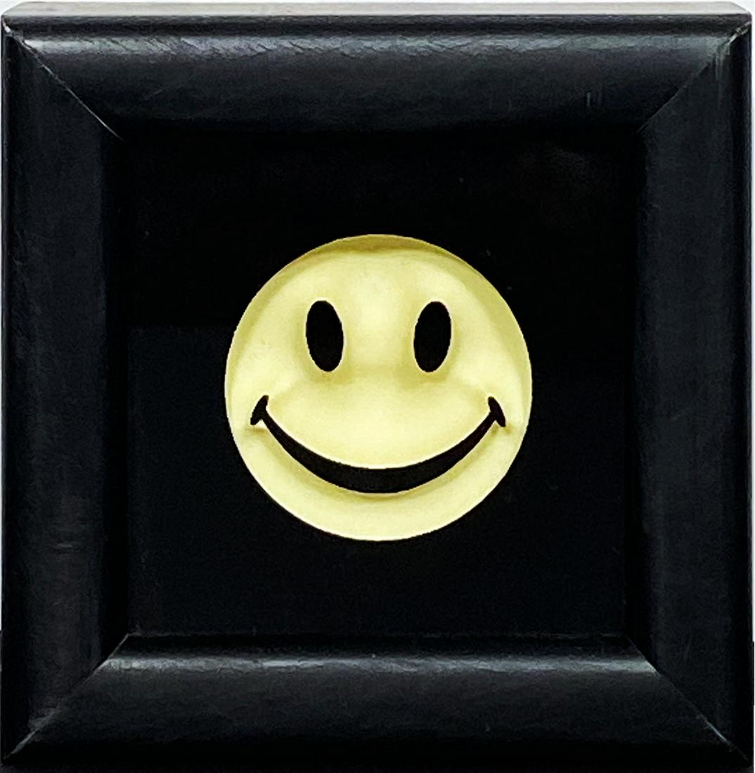 RYCA 'Mini Flouro Smiley' GID Resin Smiley Framed: 'Mini Flouro Smiley' by RYCA aka Ryan Callanan, 2014 4.75 x 4.75 x 2 Inches Glass, timber, resin, and glow-in-the-dark ink from an edition of unknown size (artist framed). Limited Edition Signed by RY
