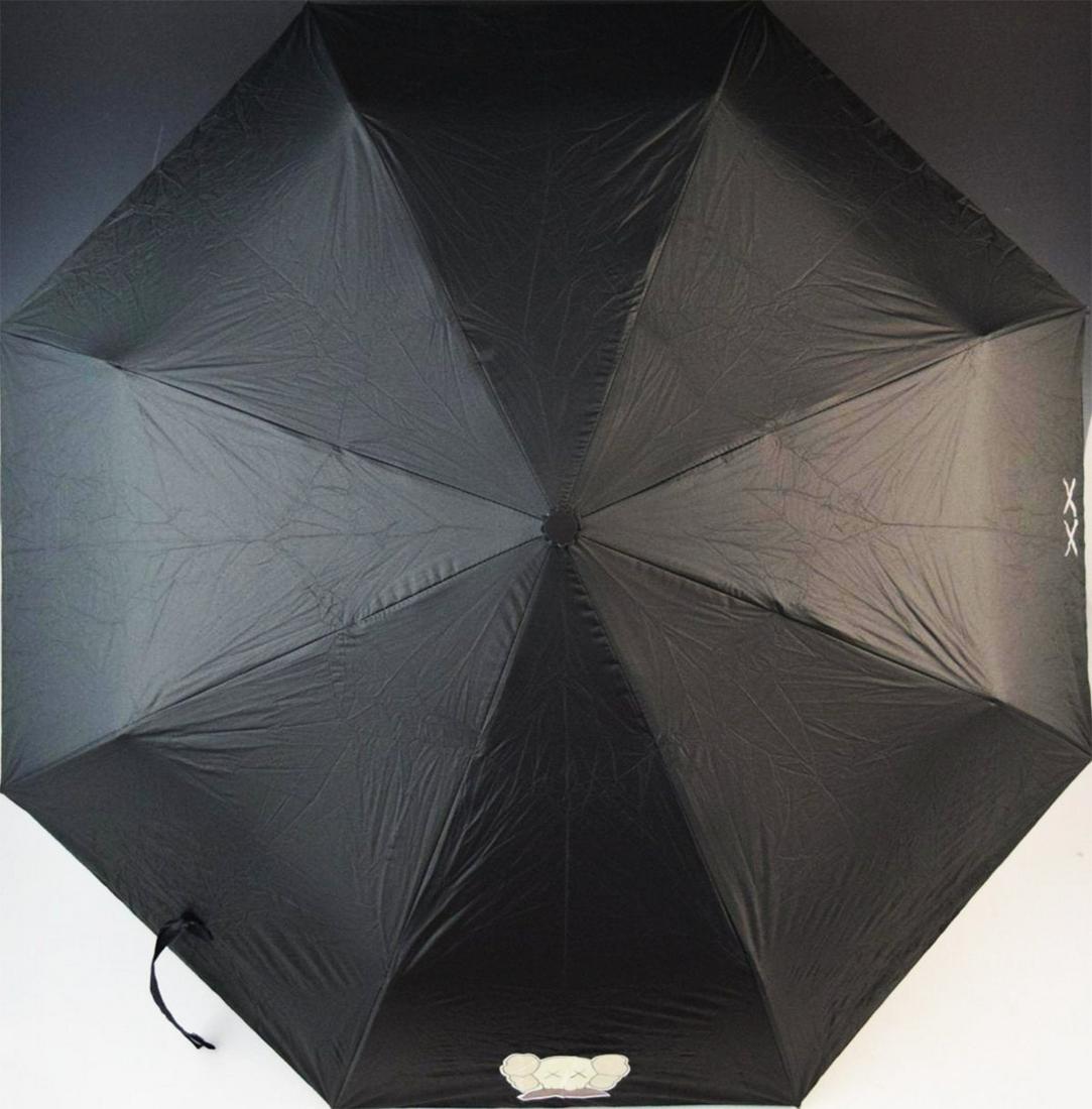 KAWS 'Holiday XX' Umbrella (black): **HELP STOP THE SPREAD OF COVID-19** 25% of Auction Proceeds will go to