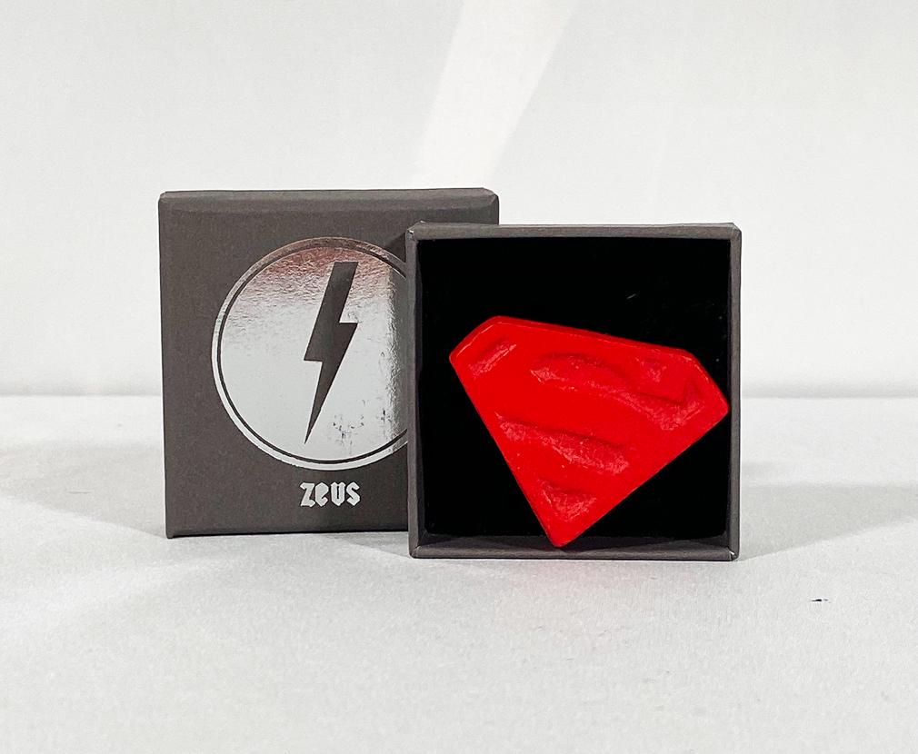 ZEUS 'Love is a Drug (Superman)' Mini-Tablet Art: 'Love is a Drug' by Zeus, 2019 Superman edition. 1.75 x 1.75 Inches Art sculpted pill tablet with engraved Superman logo. Hand-painted in red. Non-editioned multiple. Hand-signed by the artist on reve