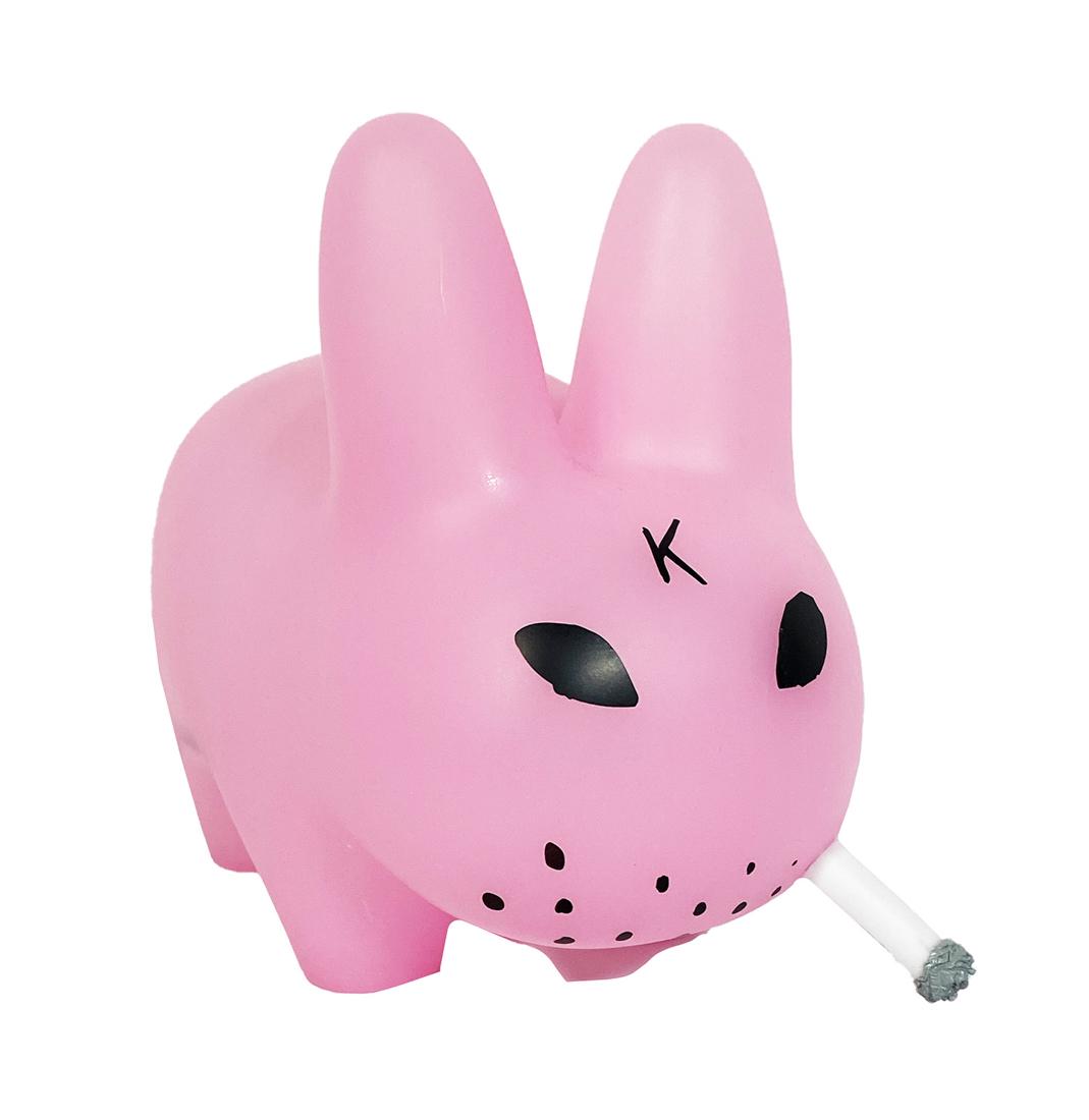 FRANK KOZIK x KidRobot 'Smorkin Labbit' (GID pink) Art: 'Smorkin Labbit' by Frank Kozik, 2012 Collab. with toymaker KidRobot. Clear pink, Glow-in-the-Dark variant. 10 Inches tall (figure) 13 x 9.5 x 7.5 Inches (box) Collectible vinyl art figure. Limited Ed