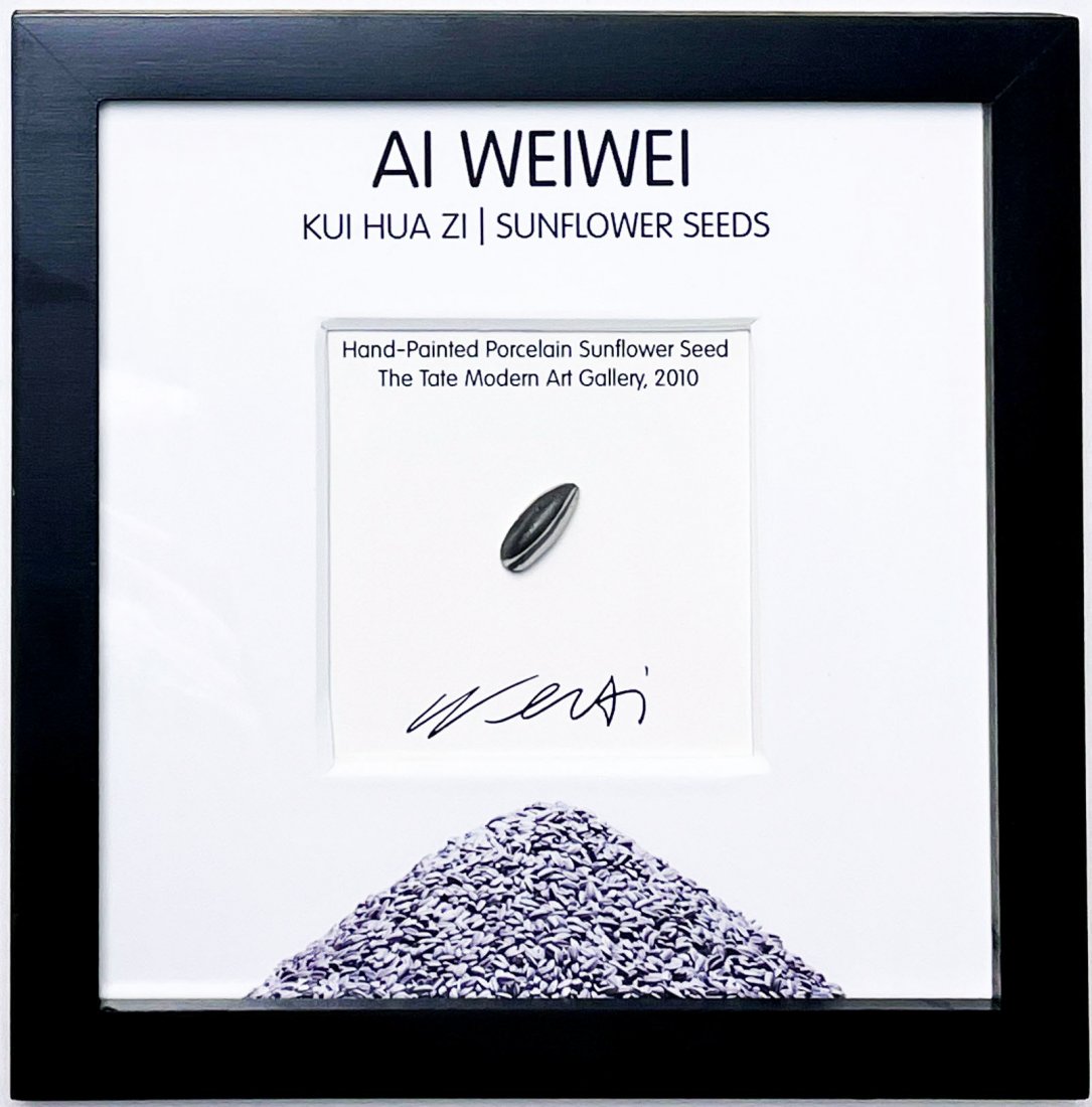AI WEIWEI 'Sunflower Seed' Hand-Painted Sculpture (Fram: 'Sunflower Seed' by Ai Weiwei, 2010 Hand-painted porcelain sunflower seed from the artist's infamous exhibit. Comes mounted on white with black hardwood frame (sunflower seed is NOT glued or affixed t
