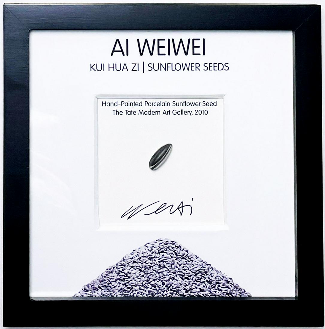 AI WEIWEI 'Sunflower Seed' Framed Hand-Painted Sculpture: 'Sunflower Seed' by Ai Weiwei, 2010 0.75 x .025 Inches each 1.9 x 0.7 Centimeters each 9 x 9 x 1 Inches (framed) Hand-painted porcelain sunflower seed from the artist's historic exhibit. Unique, limit