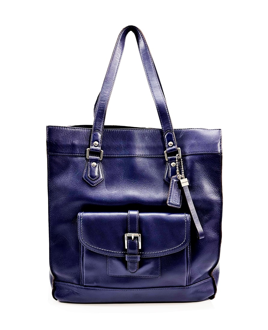 COACH 'The Charlie' (2016) Blue 100% Leather Tote Bag: 'The Charlie' by Coach, 2016 14 x 12.5 x 6 Inches 35.6 x 31.8 x 15.2 Centimeters Beautiful Space Blue tote with silver-tone hardware. Dual carry handles with magnetic buckle front pocket. Leather Coac
