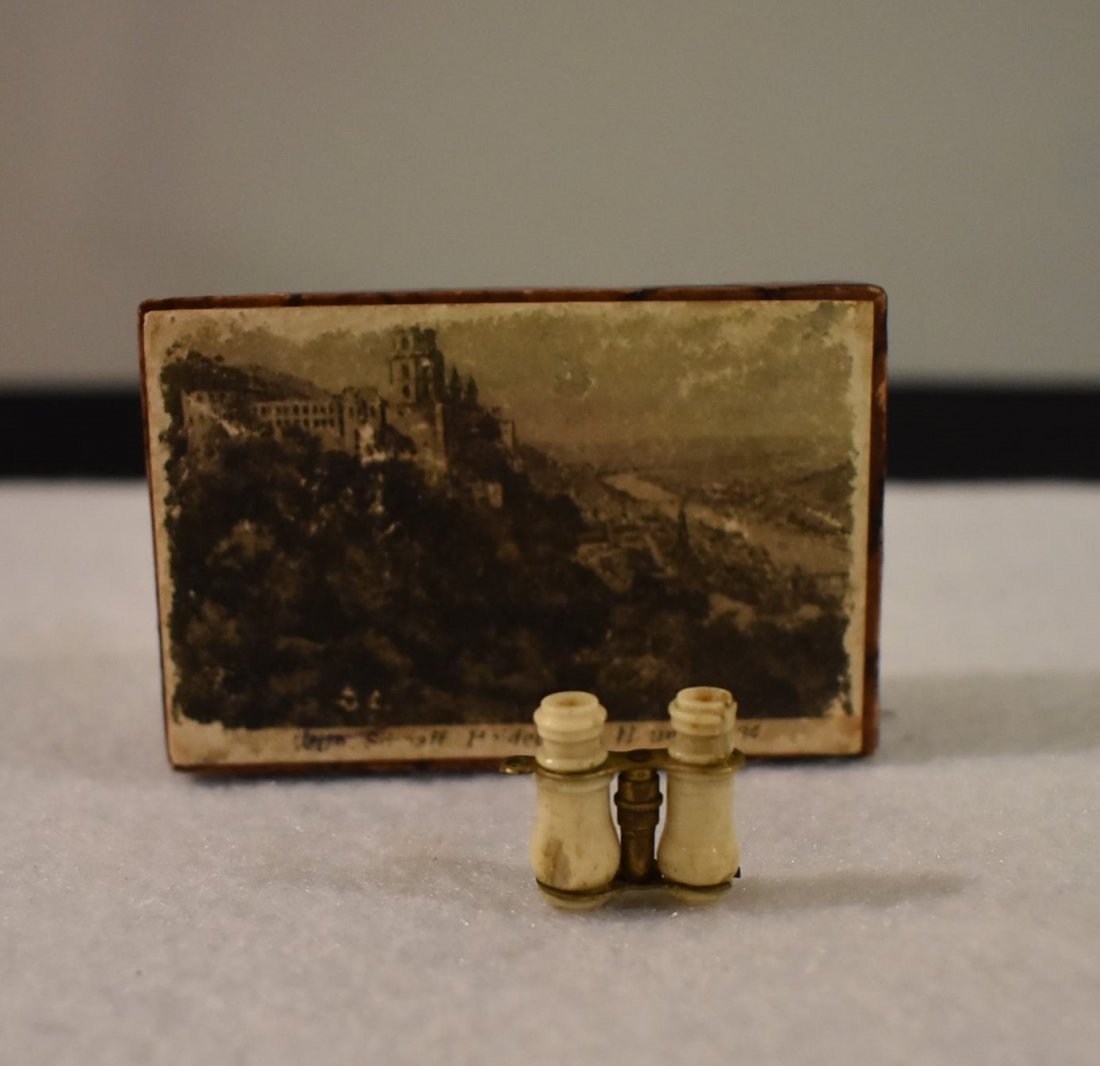 Antique German Miniature Tourist Charm Bone Binoculars: these are Antique German Miniature Bone tourist charm Binoculars with a picture of a castle view able through one of the viewing holes. these are roughly turn-of-the 20th century and are apparently fr