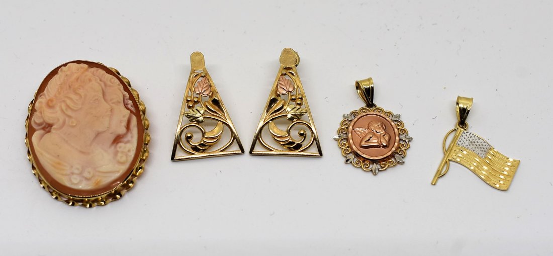 Group of 14K & 10K Gold Jewelry: A Group of Gold Jewelry including 14K Cameo, 2 14K Charms and 10K Earrings.
