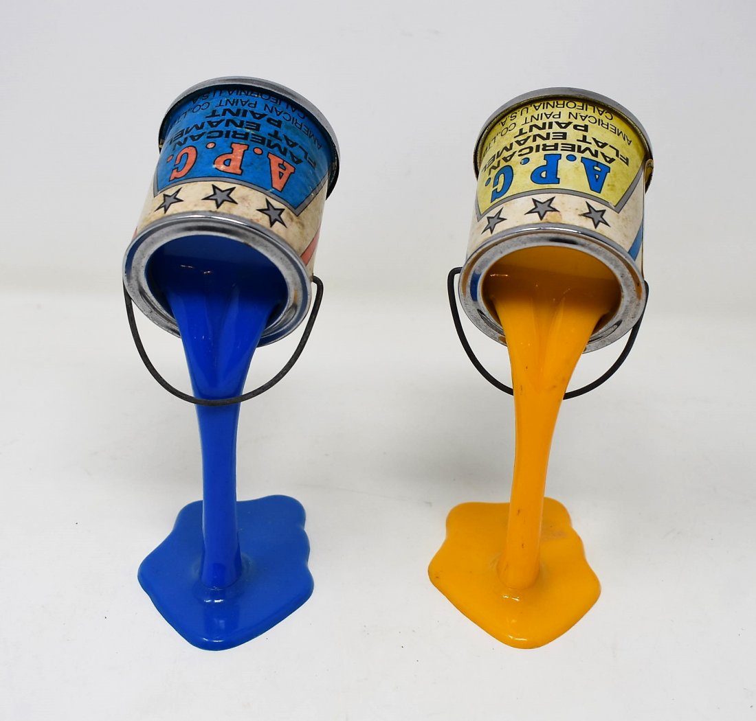 Lot of 2 Vintage Novelty Spilled Paint Can Banks A.P.G.: Lot of 2 Vintage 1970's Novelity A.P.G. Spilled Paint Can Banks. They measure 6" tall