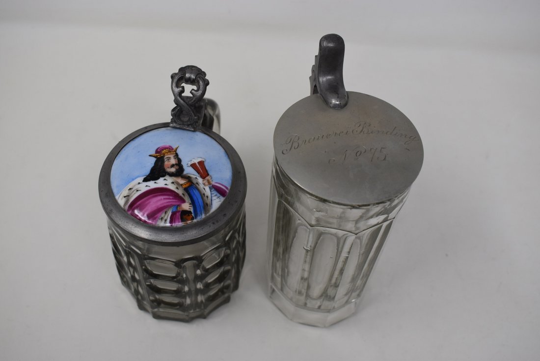 Pair of Antique Glass Beer Steins: A Pair of Steins inclduing:1/2 liter glass stein with Gambrinus inlay lid, nice shape. Has play in hinge, normal wear.0.4 liter glass stein "Brauerei Binding" no. 75 Tavern Stein?Glass has a few air b