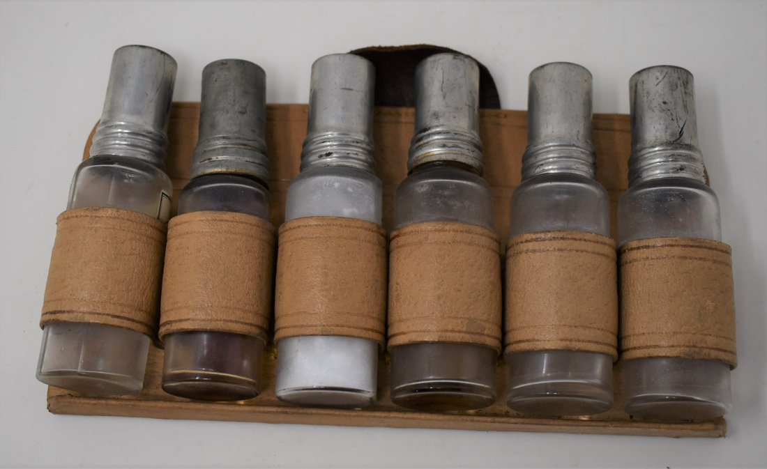 Antique Medicine Bottles in Leather Holder: Antique/Vintage Medical Medicine Bottles in Leather Holder. One bottle is different from the others. The bottles measure 4.75" tall