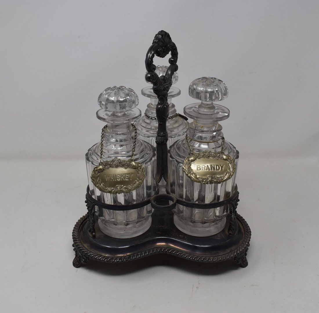 Antique Liquor Decanter Set with Tags: Antique Liquor Set, 3 Decanters with Stoppers and Tags in Silver Plate Holder. The bottles measure 7.5" tall.