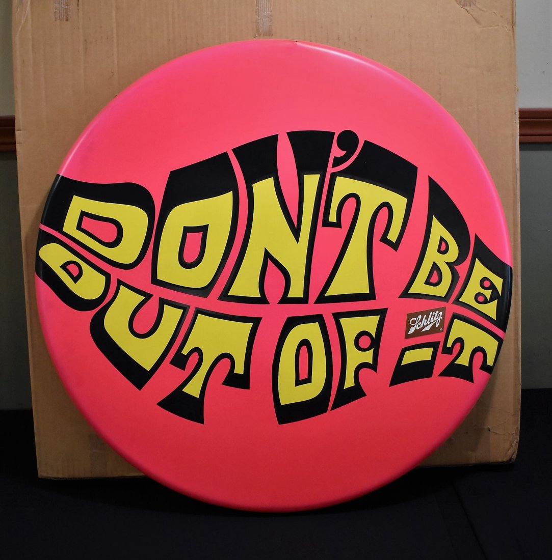 1970 Schlitz Beer Advertising Button Sign: 1970 Schlitz Beer Hot Pink Button Sign "Don't be Out of It". It measures 26" in diameter, made of plastic.