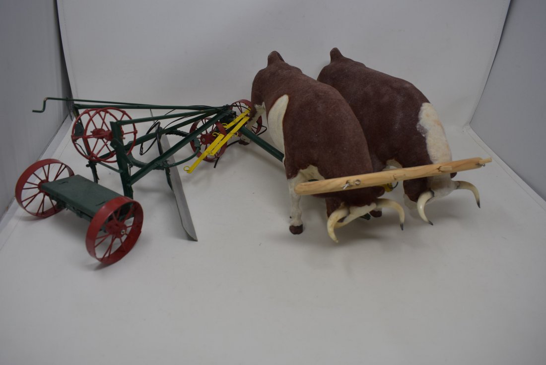 2 Flocked Breyer Bulls with Plow: A Pair of Flocked Breyer Bulls with Plow.
