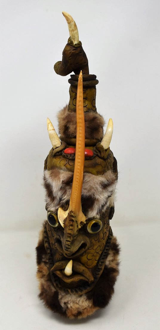Unusual Tribal Drinking Vessel: Unusual Tribal Drinking Vessel. It is made of pottery and features teeth, stones, fur, vertebrae nose and wood handle. Stopper comes out. It measures 13.5" tall and has great, weird detial!