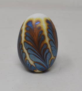 1981 Charles Lotton Art Glass Egg Paperweight: 1981 Charles Lotton Egg Shaped Paperweight with an iridescent pulled feather design, measures 2.5" tall, signed and dated.