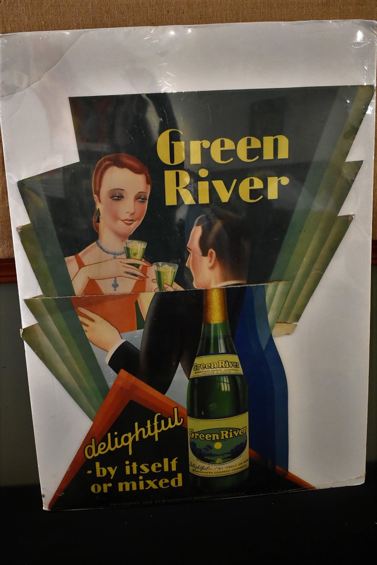 Early Deco Style Green River Soda Sign. Schoenhofen: Early Green River Sold Sign, made of cardboard, approx. 34" high. It has been stored in plastic. Great Color. It is torn in half and has some wear. It is marked Schoenhofen copyright 1929 bottom.