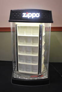 Zippo Lighter Counter Case Display Lights/Rotates: A Zippo Lighted, Rotating Counter Display Case. It measures 27" x 14" and is in great working condition. Includes key.