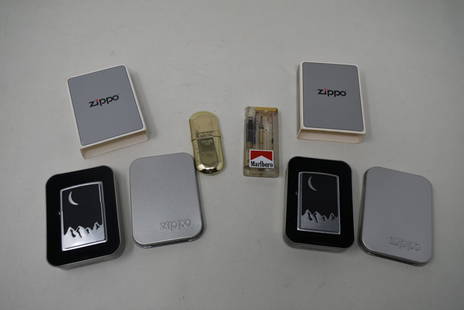 4 Vintage Marlboro Lighters: A Lot of 4 Vintage Marlboro Lighters. The Zippos are new with seals intact.