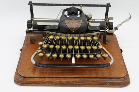 Blickensderfer No. 7 Typewriter In Wood Case: appears to work and case is in overall good shape but with broken handle strapCase: 6.5 in. H x 13 in. W x 11 in. D.