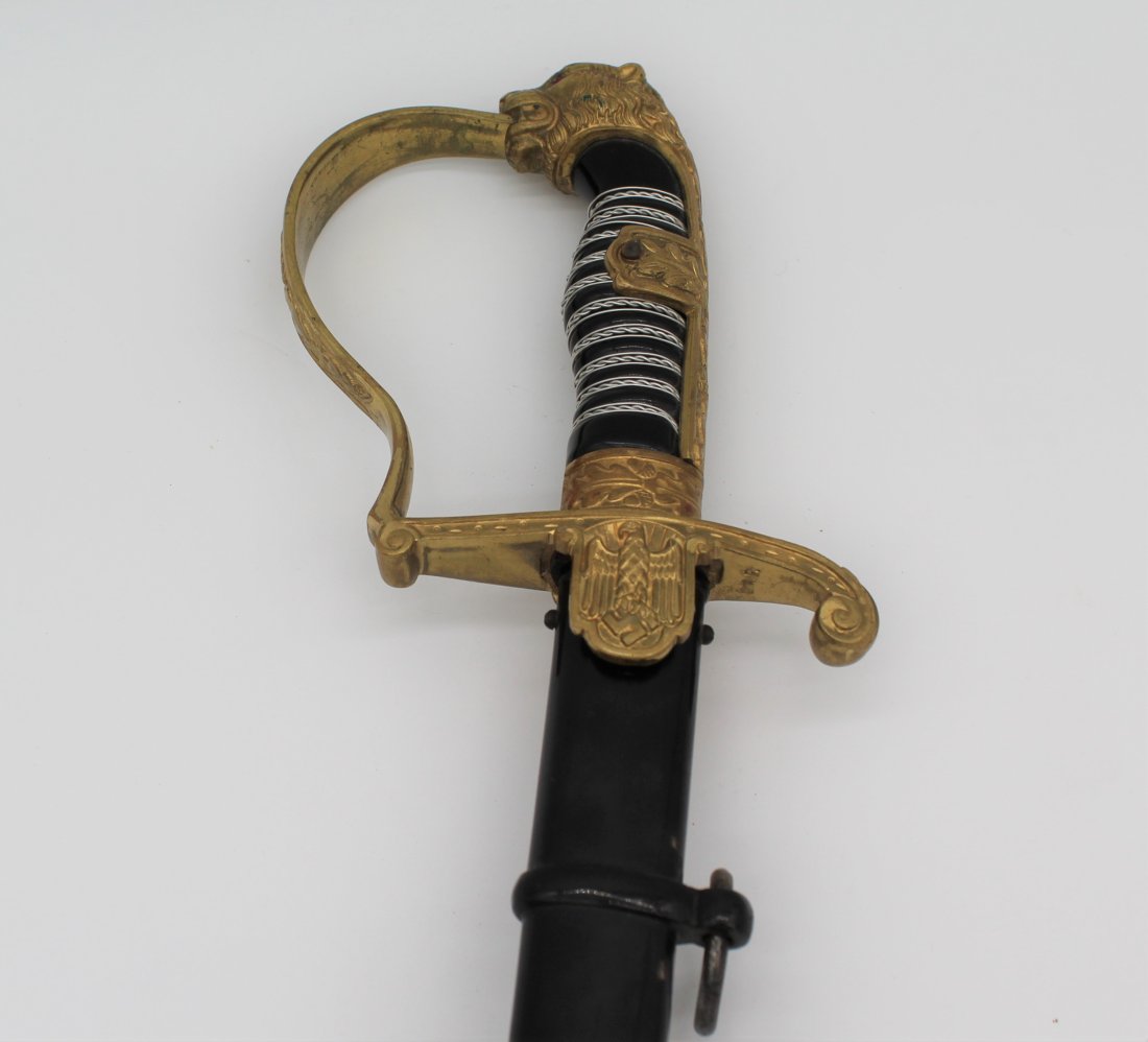 WWII German Nazi Carl Eickhorn Panther or Lion Head Sword: WWII German Nazi Carl Eickhorn Panther or Lion's Head Ceremonial Sword with Sheath.The Sword w/ sheath on is approx. 40 1/8" long - sword alone is approx. 38 1/2" long - sheath is approx. 35" long.