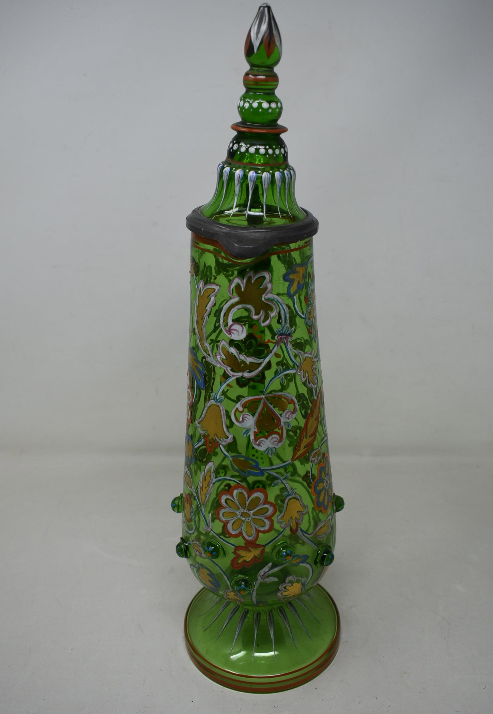 Anton Egermann Enameled Master Stein: Green Glass Stein 16.5" with enameled flower decoration with applied prunts. Anton A. Egermann, Bohemia circa 1890. The hinge has play, otherwise in excellent condition.