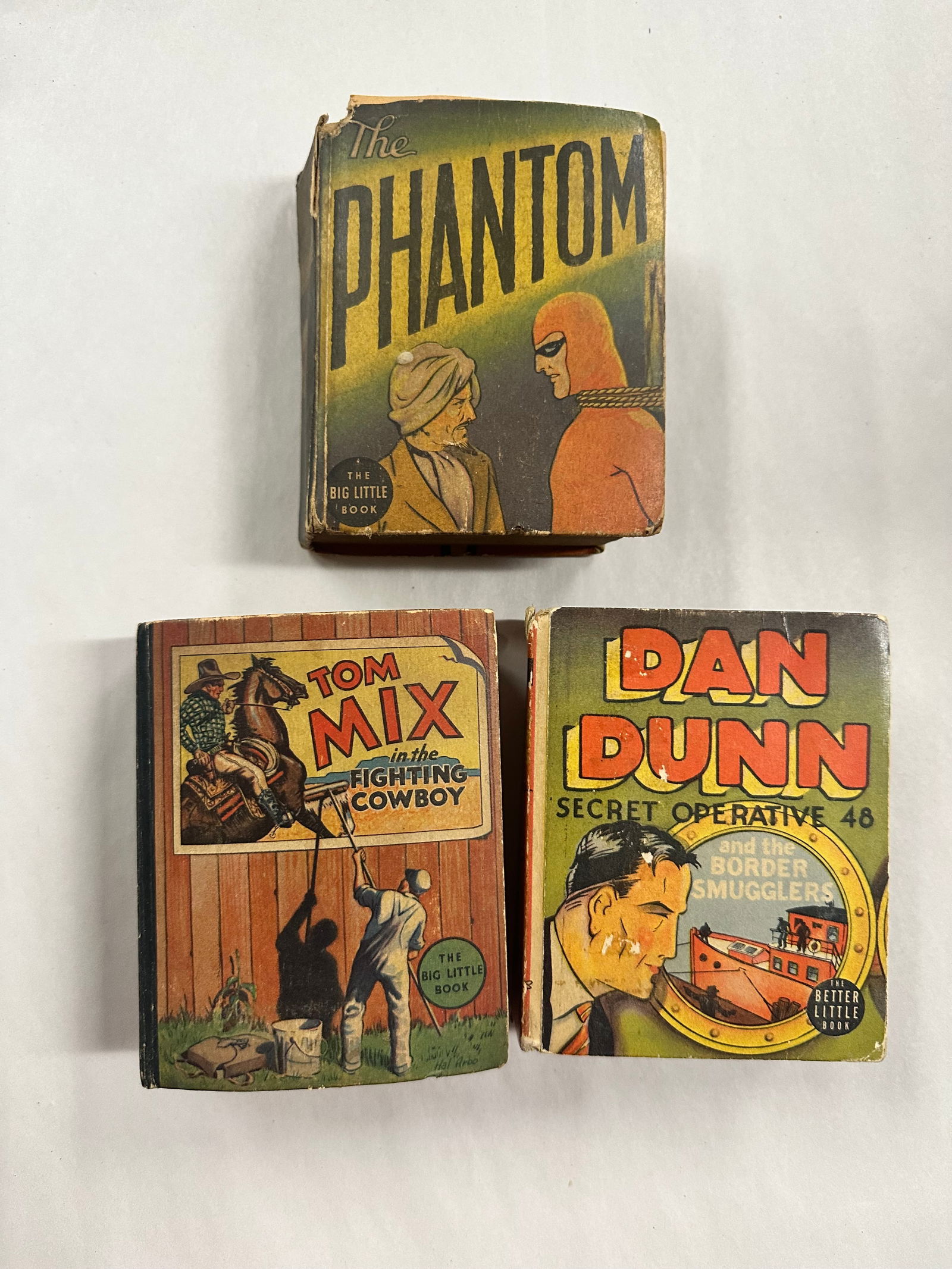 3 Big Little Books The Phantom Tom mix Dan Dunn: 3 Big Little Books The Phantom Tom mix Dan Dunn - books have brown pages, tears, bends, etc. as shown