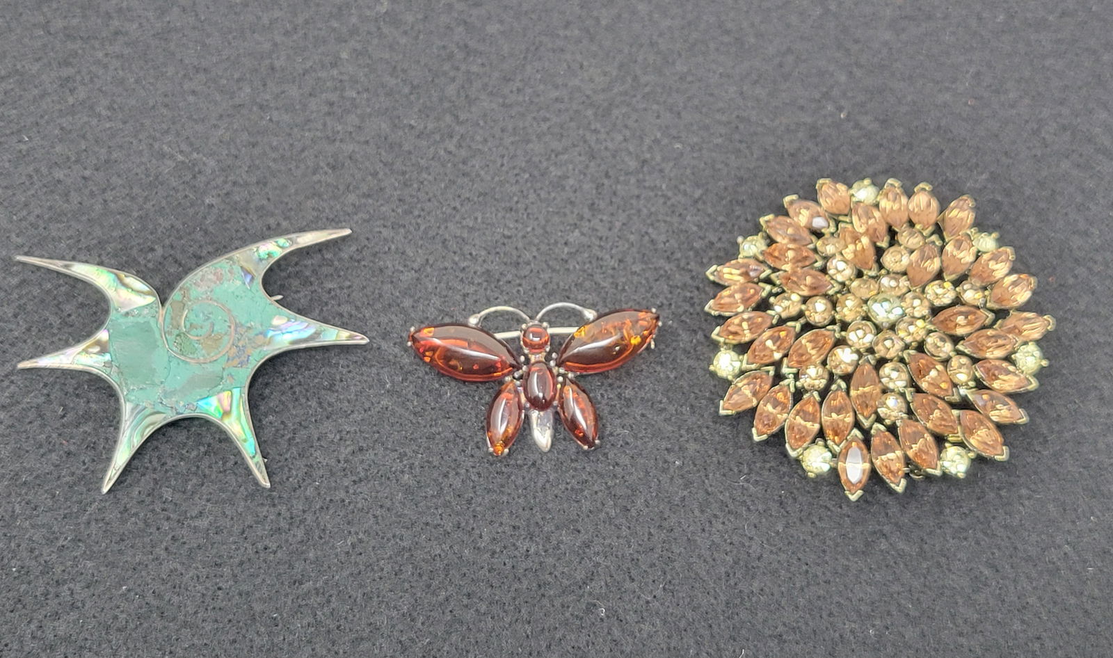 Lot of 3 Brooches including Weiss & Sterling: A Group of 3 Brooches including a Rhinestone Weiss, Sterling and Amber Butterfly and Sterling Abalone. All are in nice condition.