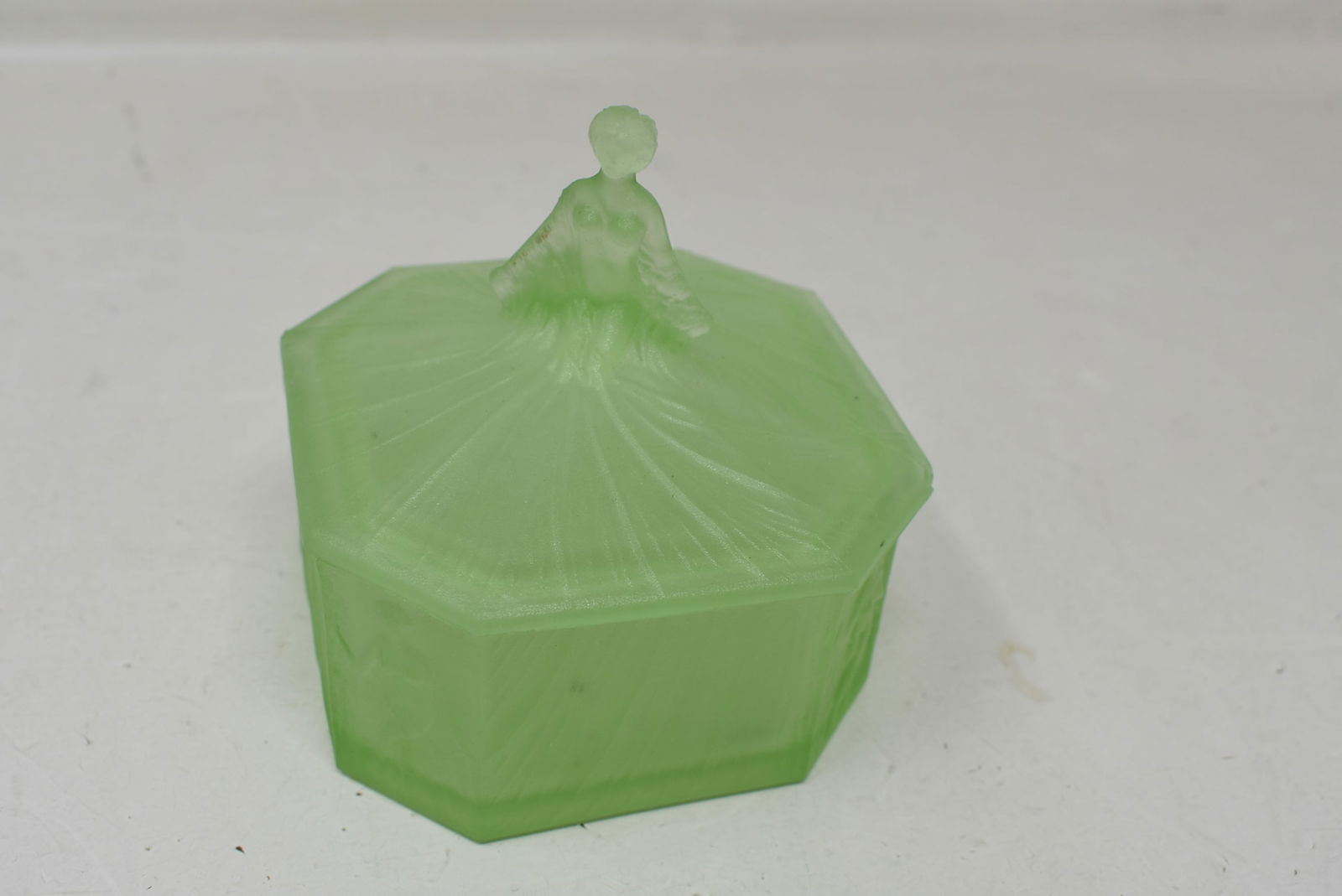 Earl Ramses Uranium Glass Nude Covered Candy Dish: Earl Ramses Uranium Glass Nude Covered Candy Dish 4"x6". It has small flea bites on edge and underside of lid. Non-distracting.