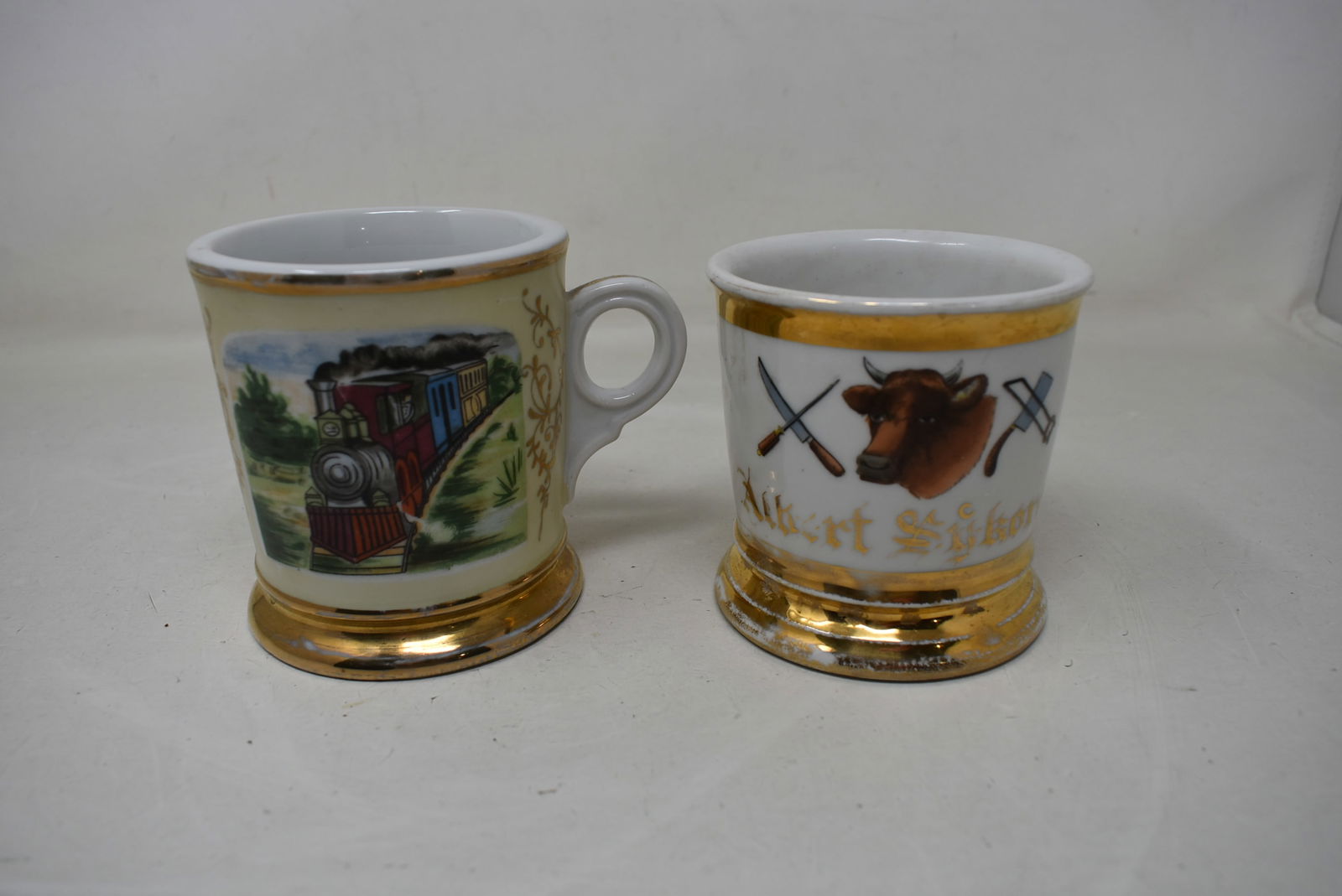 Lot of 2 Vintage Porcelain Shaving Mugs Railroad & Butcher: 2 Vintage Porcelain Shaving Mugs, Railroad and Butcher. In nice condition with light paint loss.