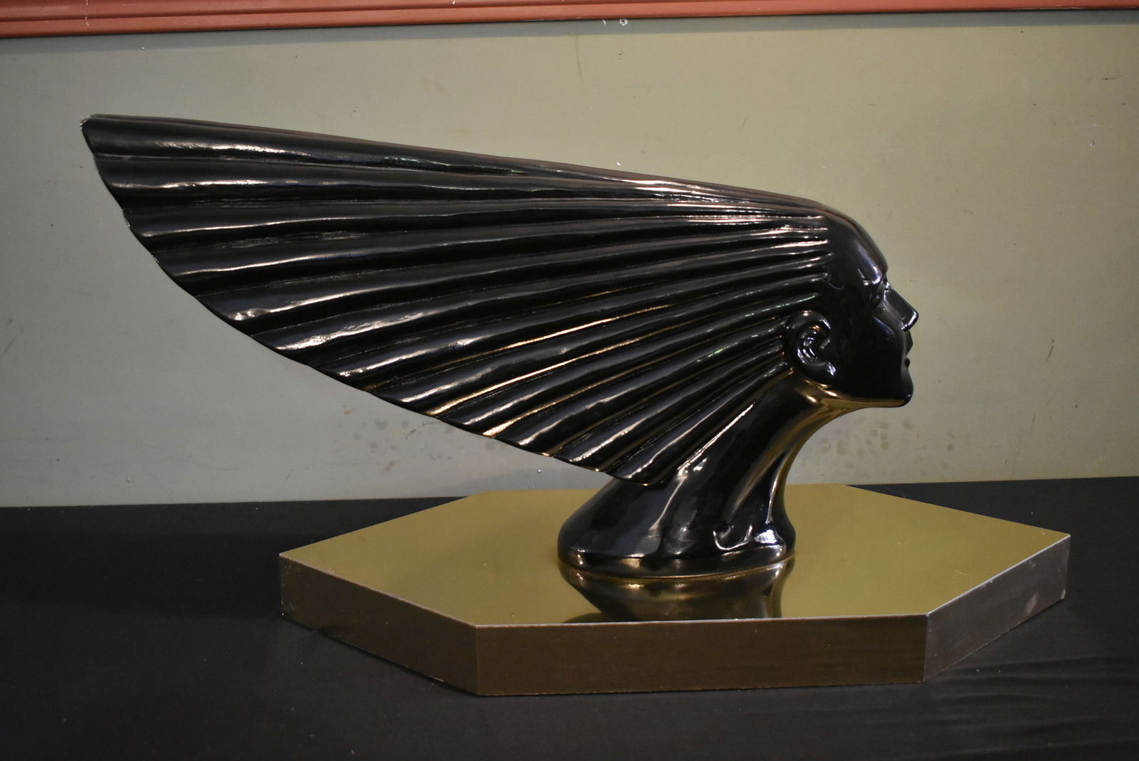 Large Art Deco "Lady Victory" Sculpture 32": Large Art Deco "Lady Victory" 32" Sculpture. It is made of some sort of composite and sits on a gold base. 32" long, 16" tall. Has a ding on the top back edge of hair and a few minor imperfections. Ve