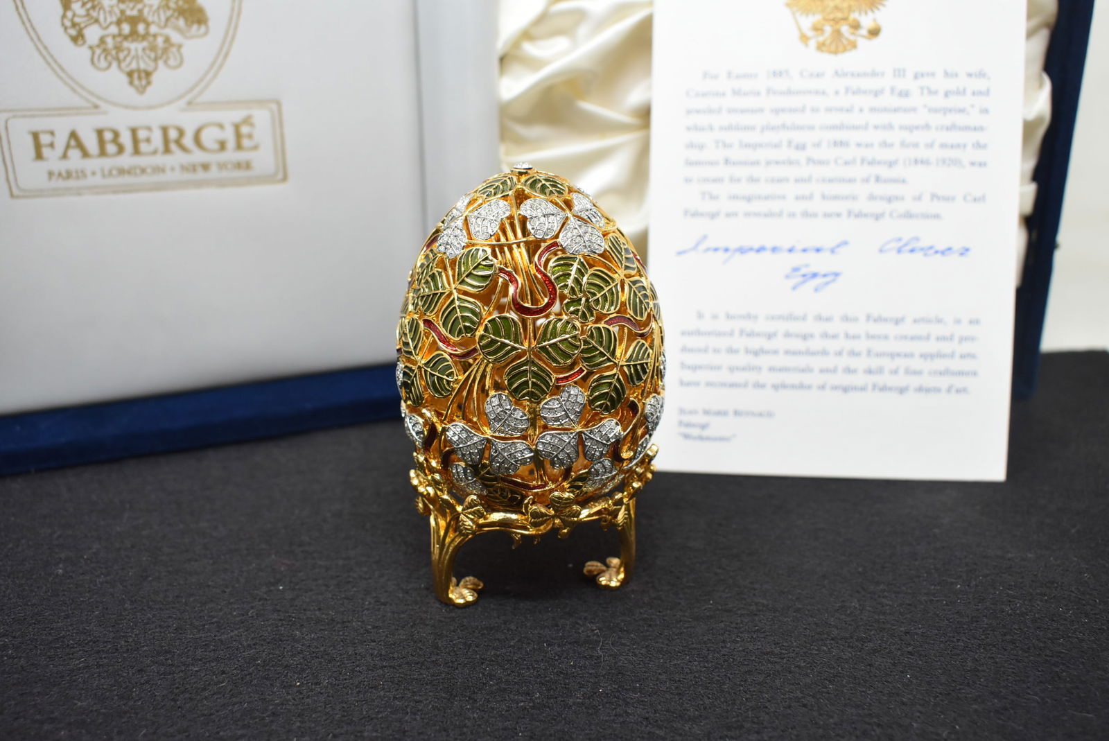Imperial Faberge Egg "Clover Egg": Imperial Faberge "Clover Egg" in Blue Velvet Box with COA. The egg itself measures 4". There is a sterling silver Clover Brooch inside of the egg.