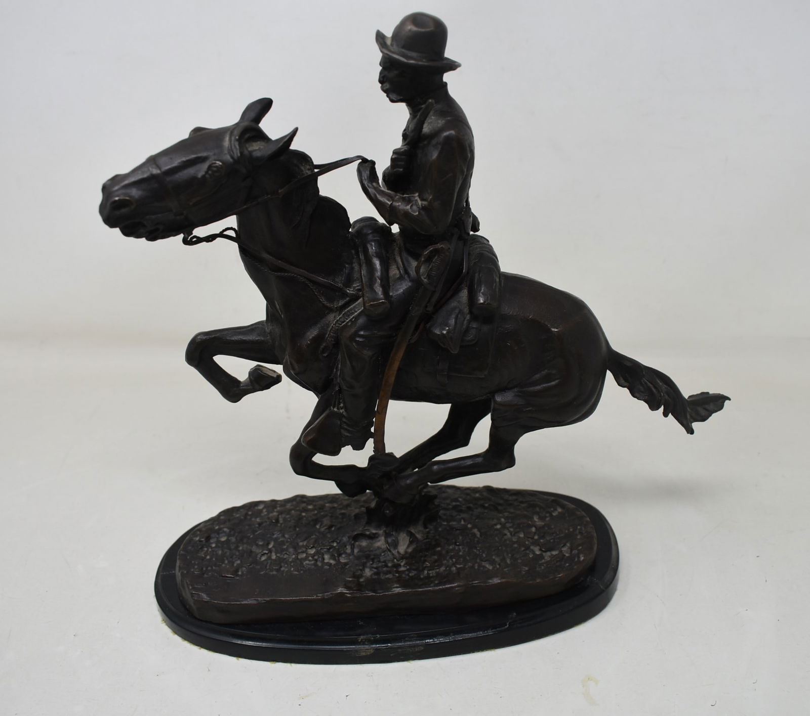 Frederic Remington "Trooper of the Plains" 12" Bronze Sculpture: After Frederic Remington "Trooper of the Plains" 12" Bronze Sculpture. In good condition, the base is loose and some discoloration of his sword.